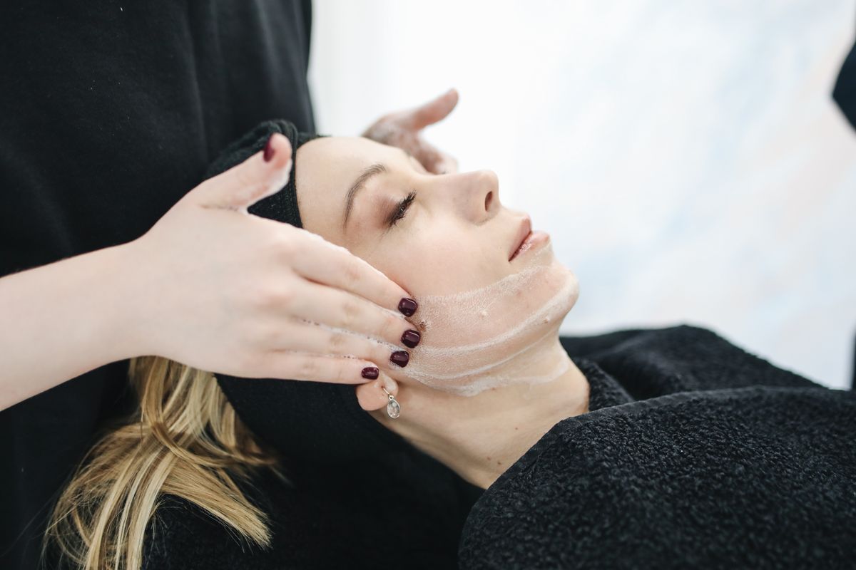 Client receiving a professional facial treatment to help address pigmentation
